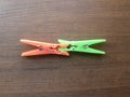 Green and orange plastic Clothespins Royalty Free Stock Photo