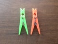 2 green and orange plastic spring Clothespins Royalty Free Stock Photo