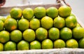 Green Oranges in the Nigerian Aboki Wheelbarrow for Consumption