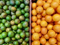 Green oranges and yellow oranges were placed in wooden crates. Royalty Free Stock Photo