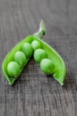 Green organic peas on wooden background Royalty Free Stock Photo