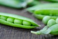 Green organic peas on wooden background Royalty Free Stock Photo