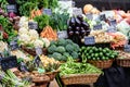 Green organic vegetables in display for sale at a street food market, with names displayed in English, carrots, white asparagus, c