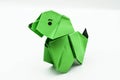 Green origami dog isolated on white background