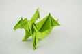 Green Origami Dragon on white background