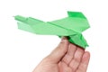 Green origami plane in the hand flying