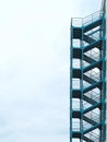 Green outside fire escape stairs ladder over cloudy sky Royalty Free Stock Photo