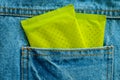 Green package of feminine sanitary napkin in back of pocket blue Royalty Free Stock Photo