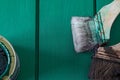 Green paint in a cun and paint brush on a wooden board Royalty Free Stock Photo