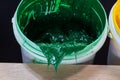 green paint dripping from white barrel. Royalty Free Stock Photo