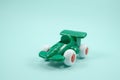 Green paint plastic toy racing car with number one isolated on turquoise Royalty Free Stock Photo