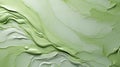 A green paint swirls on a white surface