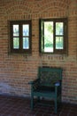 Green painted chair in brick alcove