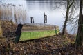 Old wooden dinghy or rowboat on a lake shore Royalty Free Stock Photo