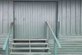 Green painted locked loading dock doors steps Royalty Free Stock Photo