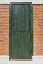 A green painted plank door cut in half with a lock and handle on the upper part Royalty Free Stock Photo