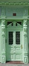 Green painted rich decorated wooden portal