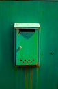 Green painted steel mail box on metal fence Royalty Free Stock Photo