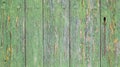 green painted wooden door worn by time with a rusty lock and with a chain hanging from it Royalty Free Stock Photo