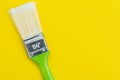 Green painting brush on solid yellow background with copy space using as art, color palette or design concept Royalty Free Stock Photo