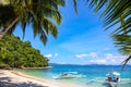 Green palm tree and white beach on sunny day. Tropical island paradise photo. Philippine island hopping tour Royalty Free Stock Photo