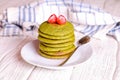 Green pancakes on a white plate for breakfast, horizontal