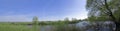 Green panorama with river and blue sky Royalty Free Stock Photo