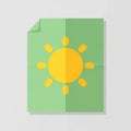 A green paper with a folded corner features a stylized sun design Royalty Free Stock Photo