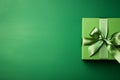 Green paper gift box on green background. Green friday, sustainable consumption, sustainability, zero waste concept. Top view.