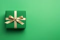 Green paper gift box on green background. Green friday, sustainable consumption, sustainability, zero waste concept. Top view.