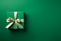 Green paper gift box on green background. Green friday, sustainable consumption, sustainability, zero waste concept. Top view.