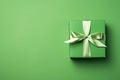 Green paper gift box on green background. Green friday, sustainable consumption, sustainability, zero waste concept. Top view.