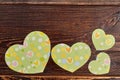 Green paper hearts on brown wood. Royalty Free Stock Photo