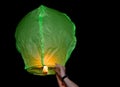 Green paper lantern being released