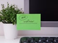 Green paper notes with the reminder 19-00 Webinar on it sticked on to a monitor at an office workplace Royalty Free Stock Photo