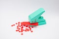 Green paper punches with red paper Royalty Free Stock Photo