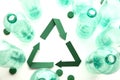 Green paper recycling symbol with empty plastic water bottles Royalty Free Stock Photo