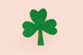 Green paper shamrock isolated on pastel pink background. Three leaf clover, top view. Minimal concept. Royalty Free Stock Photo