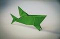 Green paper shark origami isolated on blank background