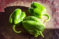 Green paprika / pepper on wooden broun table.