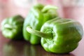 Green paprika / pepper on wooden broun table.