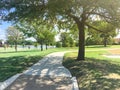 Green park with pathway from shady parking lots in Coppell, Texas, USA Royalty Free Stock Photo