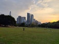 A green park with skyscrapers in the background with a beautiful sunset glow in Shenzhen, China