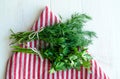 Green parsley and dill leaves on natural linen napkin on wooden background Royalty Free Stock Photo