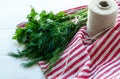 Green parsley and dill leaves on natural linen napkin on wooden background Royalty Free Stock Photo