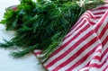 Green parsley and dill leaves on natural linen napkin on wooden background Royalty Free Stock Photo