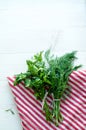 Green parsley and dill leaves on natural linen napkin on wooden background Royalty Free Stock Photo