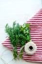 Green parsley and dill leaves on natural linen napkin on wooden background Royalty Free Stock Photo