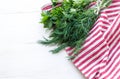 Green parsley and dill leaves on natural linen napkin on wooden background Royalty Free Stock Photo