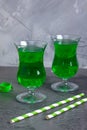 Green party beverages in irish glasses and straws